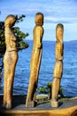 Wooden statue of people on a boat by the sea in Nea Roda