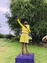 wooden statue sculpture of a wooden African American girl with hula hoop dance