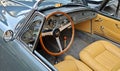 Wooden steering wheel, dash and brown leather interior of Lancia Aurelia, luxury convertible car from Fifties