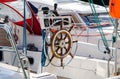 wooden steering wheel on yacht. sailboat rudder. Ropes, carbines and steering wheel of sea vessel. Royalty Free Stock Photo