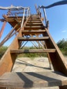 Wooden steps climbing a wooden observatory closeup view with blue sky on background