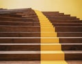 Wooden steps from wooden cubes with down arrow on yellow background