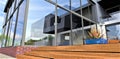 Wooden steps and glass facade. The basement is finished with red-blue brick. Reflection of the sky in mirrored windows. 3d Royalty Free Stock Photo