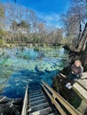 Wooden steps lead to entrance to shallow clear aqua spring waters in winter, Ginnie Springs, Florida