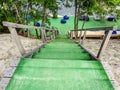 Wooden steps leading down to the beach, pond through the trees Royalty Free Stock Photo