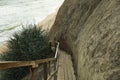 Wooden steps near clay slope on sandy beach