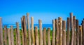 A wooden stick as fence with beautiful sea and green tree on karimun jawa island Royalty Free Stock Photo