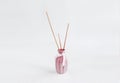 Wooden sticks for aromatherapy in a ceramic pink vase