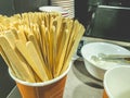 Wooden sticks for stirring hot drink. sugar in coffee and tea, stirred with a thin stick. coffee machine at gas station, self Royalty Free Stock Photo