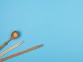 Wooden sticks for sushi and spoon on a blue background