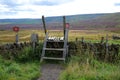 Wooden stile over moorland drystone wall