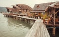 Wooden stilt houses near the port of a tropical island. Thailand. Ocean bay with traditional homes in South-Eastern Asia Royalty Free Stock Photo