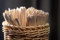 Wooden stirring sticks are in a wicker basket Royalty Free Stock Photo