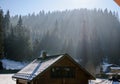 Wooden and stone house in winter. Snowy roofs. Royalty Free Stock Photo