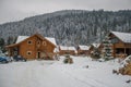 Wooden and stone house in winter. Snowy roofs. Royalty Free Stock Photo