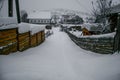 Wooden and stone house in winter. Snowy roofs. Royalty Free Stock Photo