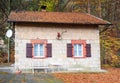 Wooden and stony cottage house in a forest in the mountains Royalty Free Stock Photo