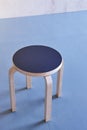 Wooden stool on an empty room. Blue floor Royalty Free Stock Photo