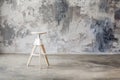 Wooden stool with grunge wall on background Royalty Free Stock Photo