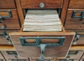 Wooden storage boxes with index book in library