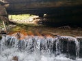 Wooden structure artificial waterfall under the man-made bridge Channel concept Royalty Free Stock Photo