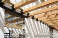 The wooden structure of the building. Installation of wooden beams at construction the roof truss system of the house.