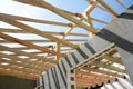 The wooden structure of the building. Installation of wooden beams at construction the roof truss system of the house.