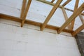 The wooden structure of the building. Installation of wooden beams at construction the roof truss system of the house.