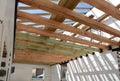 The wooden structure of the building. Wooden roof frame building. TFB system comprises thermo blocks filled with concrete.