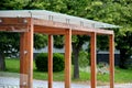 Wooden structure of the bus stop, the shelter of the gazebo pergola. the roof and walls are lined with glass. the glass is anchore