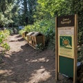 Wooden Structures on a Forest Path with a Sign About Composting Royalty Free Stock Photo