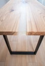 Wooden stylish table made of solid wood with epoxy resin on the background of the floor and wall. Close-up Royalty Free Stock Photo