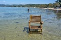 Wooden summer chair on the beach in the water