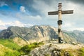 Wooden summit cross and summer colors in mountains. Bavarian Alps.