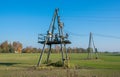 Wooden supports high-voltage power lines against the blue sky. Electrical industry