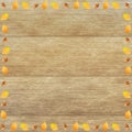 Wooden surface with autumn leaves and nuts frame - perfect for a background or wallpaper