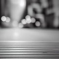 Wooden surface with a background of blurred, bokeh lights, grayscale, copy space Royalty Free Stock Photo
