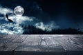 Wooden surface and bats flying in night sky with full moon. Halloween illustration Royalty Free Stock Photo