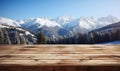 Wooden surface foreground with a magical winter landscape background snow covered pine trees and majestic snow capped mountains Royalty Free Stock Photo