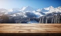 Wooden surface foreground with a magical winter landscape background snow covered pine trees and majestic snow capped mountains Royalty Free Stock Photo