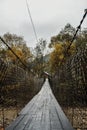 Wooden suspension bridge over a mountain river in a mountain village 2 Royalty Free Stock Photo