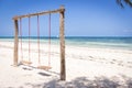 Wooden swing on the beach. Swing with two seats on scenic seascape. Idyllic exotic resort. Tropical paradise. Empty swing.