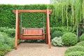 Wooden swing chair in natural green garden. Beautiful garden furniture Royalty Free Stock Photo