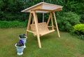 Wooden swing in the garden on the green grass Royalty Free Stock Photo