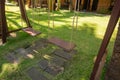 Wooden swing hanging in a beautiful garden near the bungalow. The inner territory of a beautiful hotel on the seafront Royalty Free Stock Photo