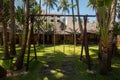 Wooden swing hanging in a beautiful garden near the bungalow. The inner territory of a beautiful hotel on the seafront Royalty Free Stock Photo