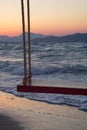 Wooden swing on the beach in sunset Royalty Free Stock Photo