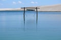 Wooden swing in the middle of a lagoon of crystal blue waters. Royalty Free Stock Photo