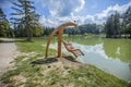 Wooden swing over Lake Bloke in Nova Vas, Slovenia on a sunny day