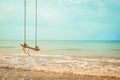 Wooden swing on tropical beach Royalty Free Stock Photo